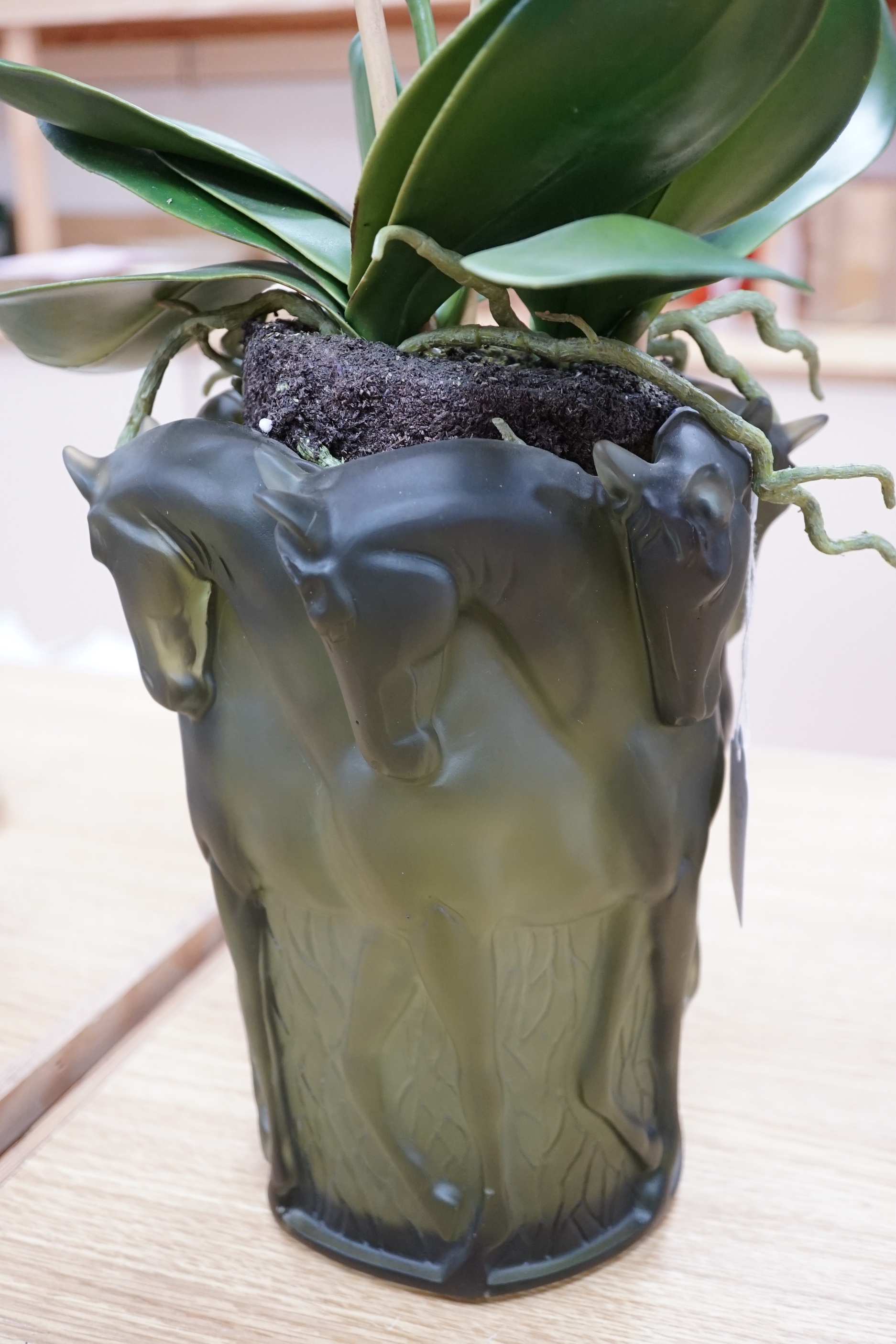 A pair of green glass Lalique style 'Haviland' signed vases with horse design and faux orchid plants within, 26cm high